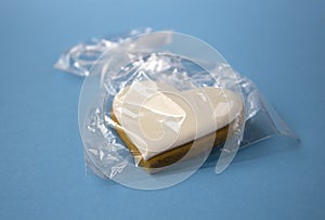 Appetizing gingerbread with white frosting  close-up on a blue background