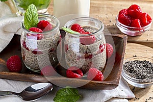 Appetizing, healthy and refreshing chia seed pudding with fresh raspberries, mint leaves and cookies. Vegetarian and vegan food