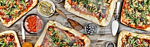 Appetizing homemade pizza on a wooden table. Friendly feast at home.