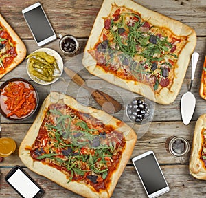 Appetizing homemade pizza on a wooden table.rustic style Friendly feast at home.