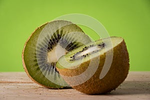 Appetizing kiwi with green background.