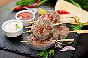Appetizing kofta kebab (meatballs) with sauce