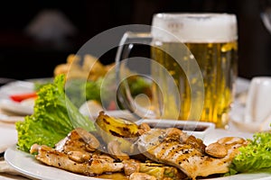 Appetizing Main Course with Dipping Sauce and Beer