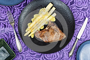 Appetizing meat steak with white asparagus