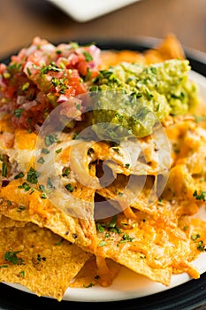 Appetizing Nachos dish garnished with sauce