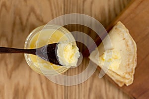 Appetizing pancakes with butter on a wooden table