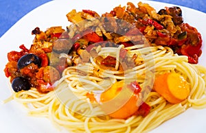 Appetizing pasta with vegetables grilled meat and two baked egg