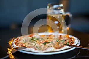 Appetizing pizza for beer. Blurred background. Real scene in bar or in pub. Beer culture, Craft brewery, uniqueness beer