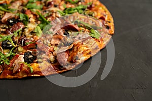 Appetizing pizza with smoked sausages bacon meat tomato cheese arugula