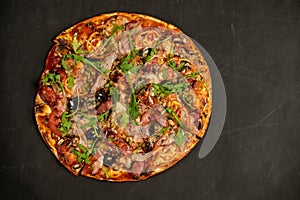 Appetizing pizza with smoked sausages bacon meat tomato cheese arugula