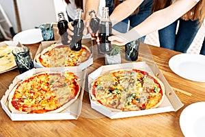 Appetizing pizza on the table and hands above it