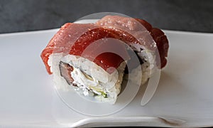 Appetizing plate of sushi rolls on a white ceramic plate