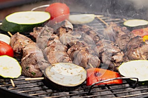 Appetizing pork with vegetables is cooked in the grill