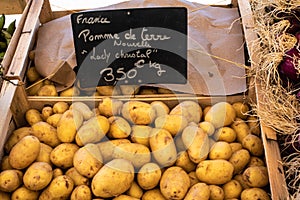 Crate of potatoes close-up on a market stall photo