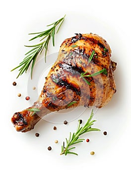 An appetizing roasted chicken leg surrounded by fresh rosemary and mixed peppercorns on a white backdrop, ready for