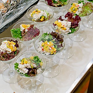 Appetizing salad in a transparent salad bowl, food closeup