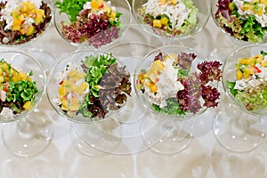 Appetizing salad in a transparent salad bowl, food closeup