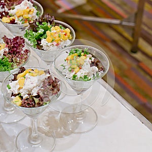 Appetizing salad in a transparent salad bowl, food closeup