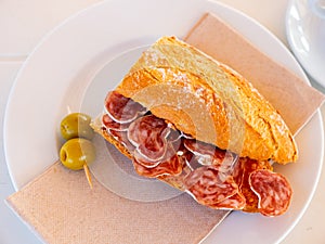 Sandwich with delicious delicaty dried sausage Fuet