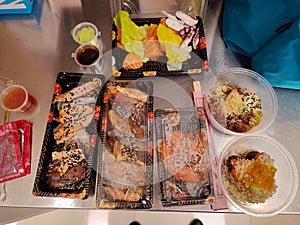 Appetizing trays of oriental food with sushi, prawns, various fried for dinner