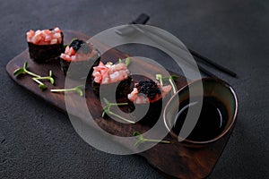 Appetizing tuna gunkan sushi set on black plate