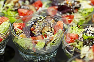 Appetizing vegetable salads in portioned dishes on the buffet table. Coffee break, business meetings and celebrations. Close-up