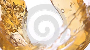 An appetizing wave of apple juice swirls inside the glass