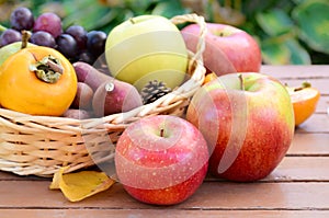 Apple and autumn fruits in a basket