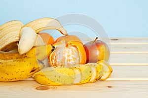 Apple, Bananas, mandarines on table