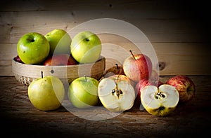 Apple and basket on wooden table,