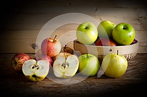 Apple and basket on wooden table,