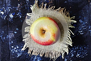 Apple on a black background wooden table linen napkin