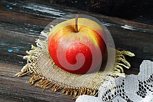 Apple on a black background wooden table linen napkin