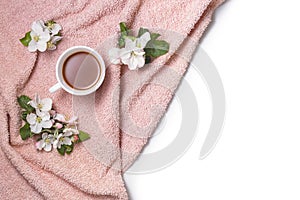 Apple blooming with cup of coffee on fur towel flat lay copy space