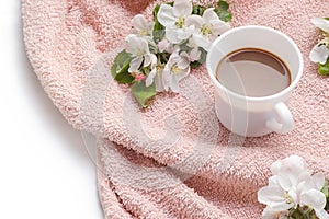 Apple blooming with cup of coffee on fur towel flat lay copy space