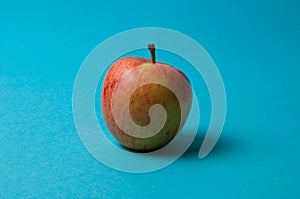 Apple on a blue background. Healthy eating, calorie count and weight loss concept