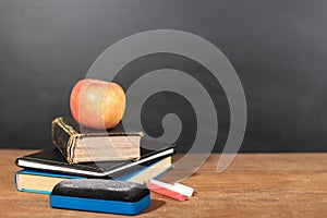 Apple, Books and Chalks with Blackboard Background