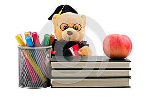 Apple, books, markers and teddy bear