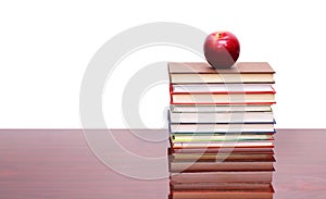 Apple with books on wood desk