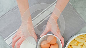 Apple cake recipe. Ingredients for baking needs close-up on a kitchen table, woman hands