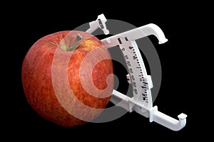 Apple and Calipers Over Black photo