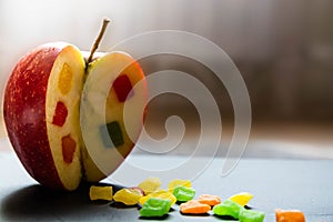 The apple with a candied fruit inside. Close up view on the side of Incised apple.