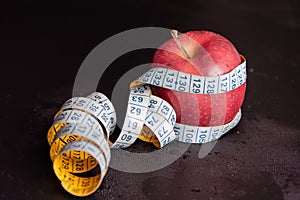 Apple and centimeter on a black background