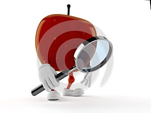 Apple character looking through magnifying glass