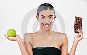 Apple, chocolate and portrait of woman for healthy food choice, sugar and beauty isolated on studio white background