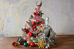 An apple christmas tree and bottle of champagne