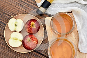 Apple cider vinegar on wooden board, Kombucha tea with apple slices.