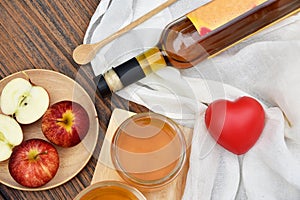 Apple cider vinegar on wooden board, Kombucha tea with apple slices, Healthy probiotic nutrition drink.