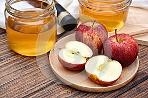 Apple cider vinegar on wooden board, Kombucha tea with apple slices, Healthy probiotic nutrition drink.