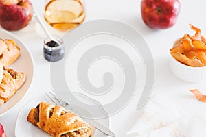 Apple cinnamon pastry rolls on white wooden table
